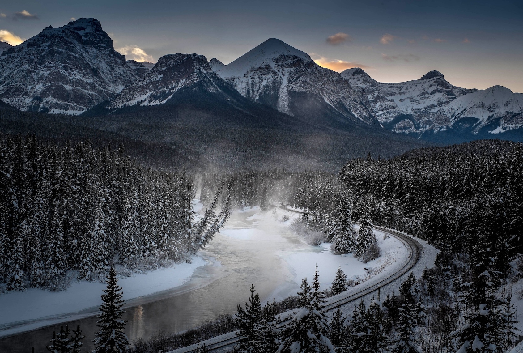 A view of the famous 'Morant's Curve' offering a beautiful view of the frozen Bow River and the Canadian Pacific Railway at Banff National park near Lake Louise, Canada, late on December 06, 2013. (Photo by JOE KLAMAR/AFP via Getty Images)
