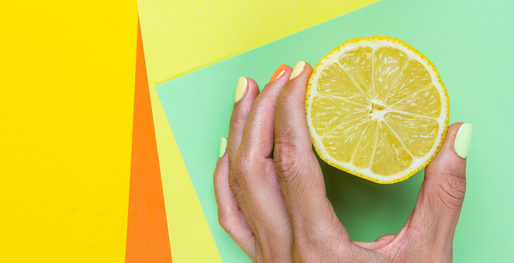 Hand holding half of a lemon (Black Lollipop/ Getty Images )