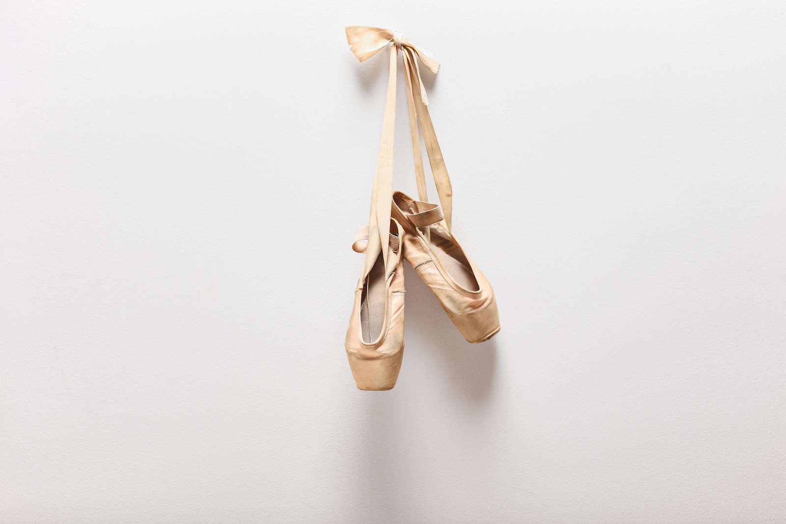 Pair of old ballet shoes hanging on a wall (ljupco / Getty Images)