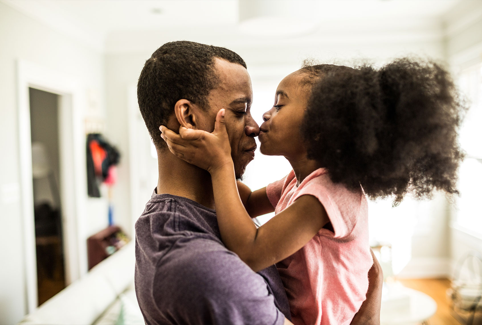 Daughter kissing father on the nose (Getty Images)