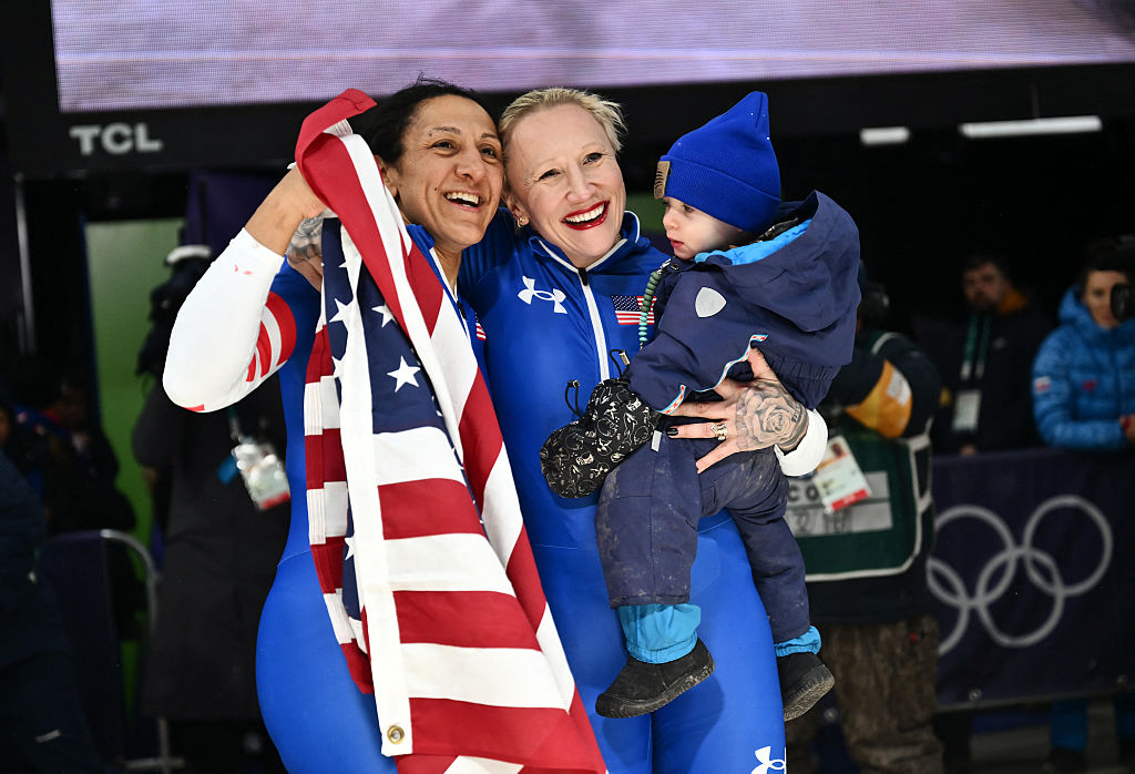 USA's Elana Meyers Taylor and USA's Kaillie Armbruster Humphries pose for pictures after winning gold and bronze respectively in the bobsleigh women's monobob heat 4 at the Milano Cortina 2026 Winter Olympic Games. Taylor and Humphries have both spoken openly about balancing motherhood and Olympic competition. (Marco BERTORELLO / AFP via Getty Images)