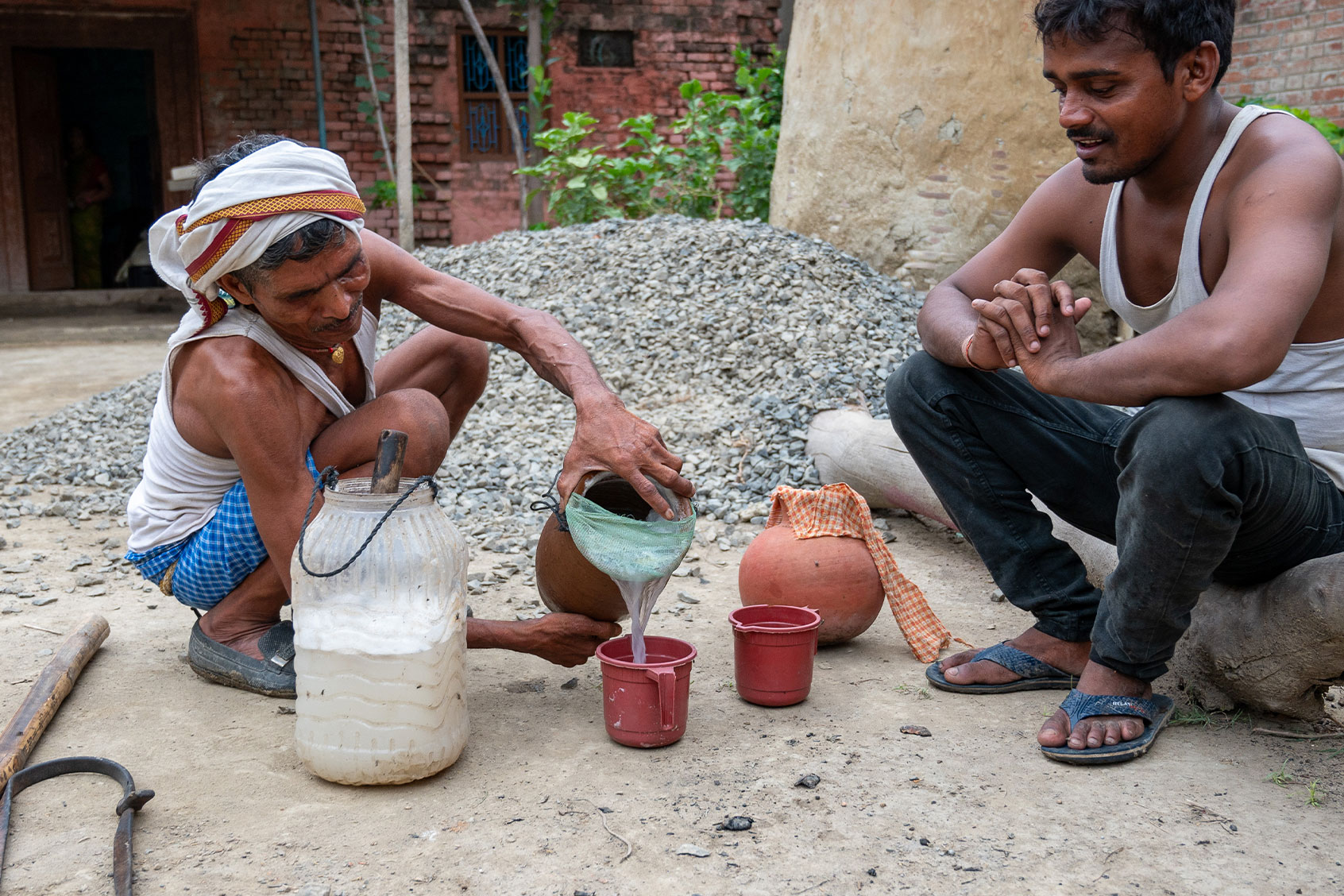 A Man from Pasi community (a Dalit or untouchable community of India) serving toddy (Palm wine), a traditional alcoholic drink made from the sap of palm trees. (Pradeep Gaur/SOPA Images/LightRocket via Getty Images)