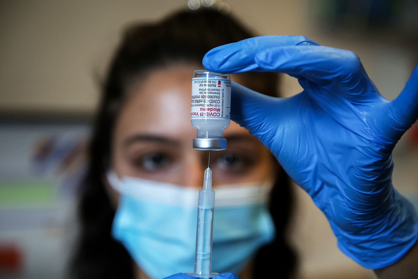 A NHS vaccinator prepares to administer the Moderna Covid-19 vaccine to a member of public at a vaccination centre in London. (Dinendra Haria/SOPA Images/LightRocket via Getty Images)