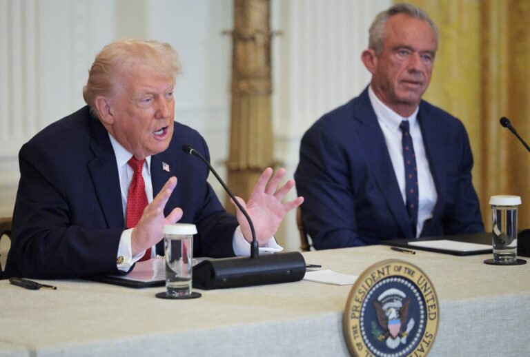 President Donald Trump speaks as U.S. Secretary of Health and Human Services Robert F. Kennedy Jr. looks on during a "Great, Historic Investment in Rural Health Roundtable" in the East Room of the White House on January 16, 2026 in Washington, DC. (Photo by Chip Somodevilla/Getty Images)